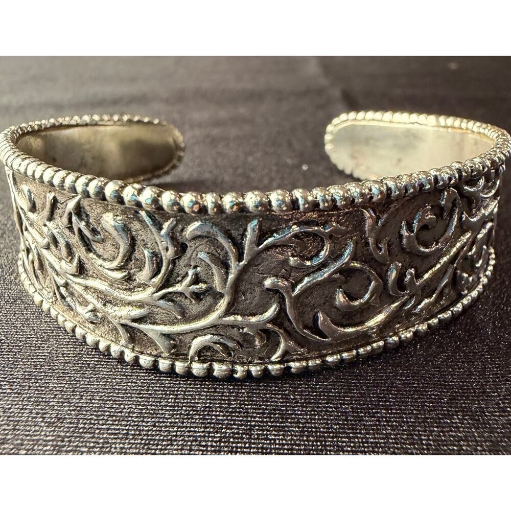 Vintage Sara Blaine cuff bracelet featuring intricate scrollwork in silver tone